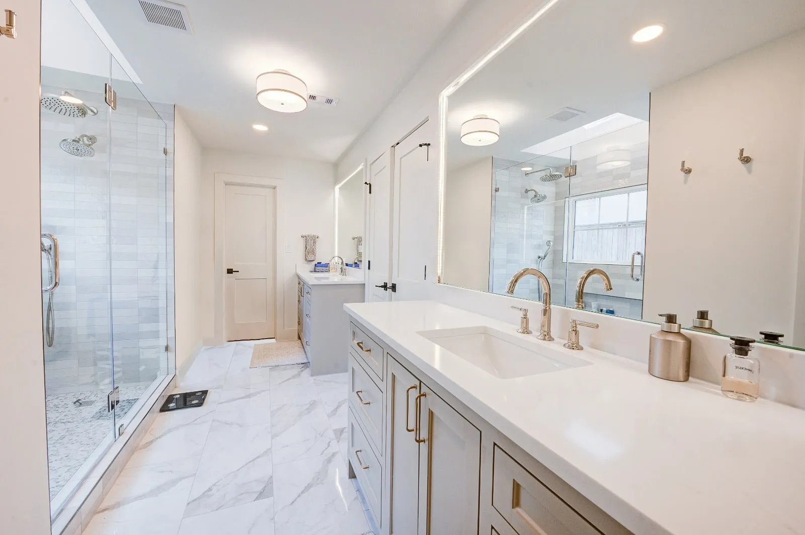 Marble bathroom with frameless glass and brushed nickel fittings in Carlton Woods, The Woodlands, TX