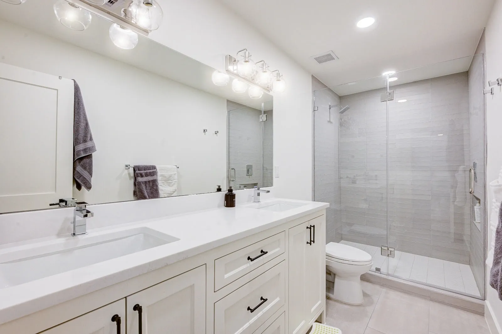 Marble bathroom with frameless glass and brushed nickel fittings in Carlton Woods, The Woodlands, TX