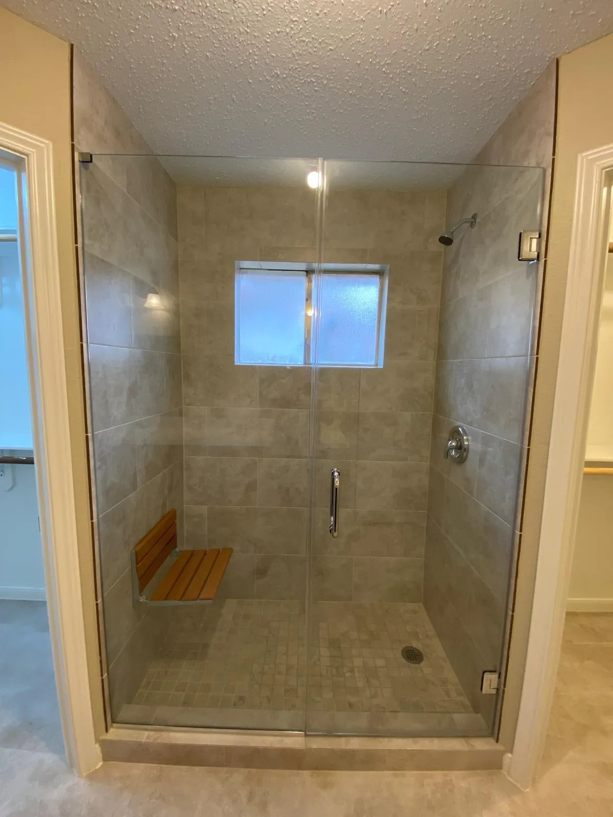 Bathroom remodel with a double vanity and a tiled walk-in shower in Cochran’s Crossing, The Woodlands, TX