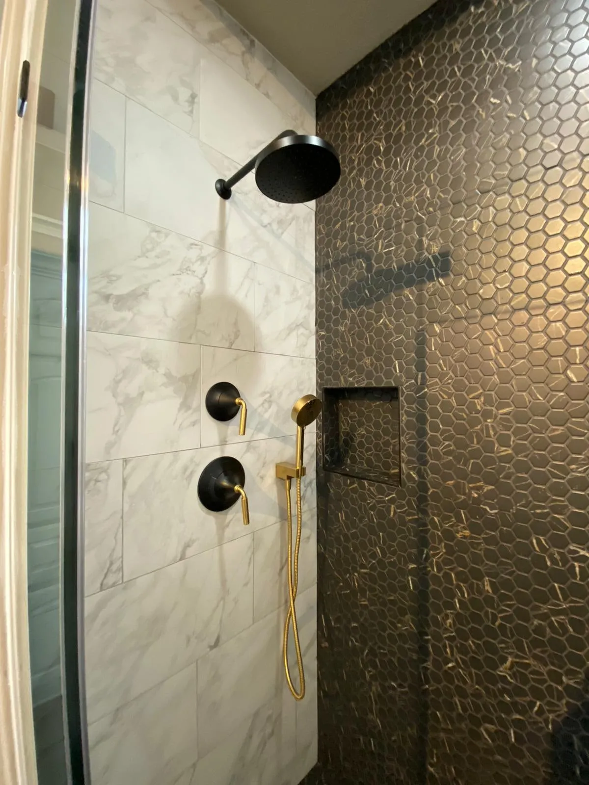 Bathroom remodel with a clawfoot tub, sage cabinetry, and gold penny-round shower tile in The Woodlands, TX