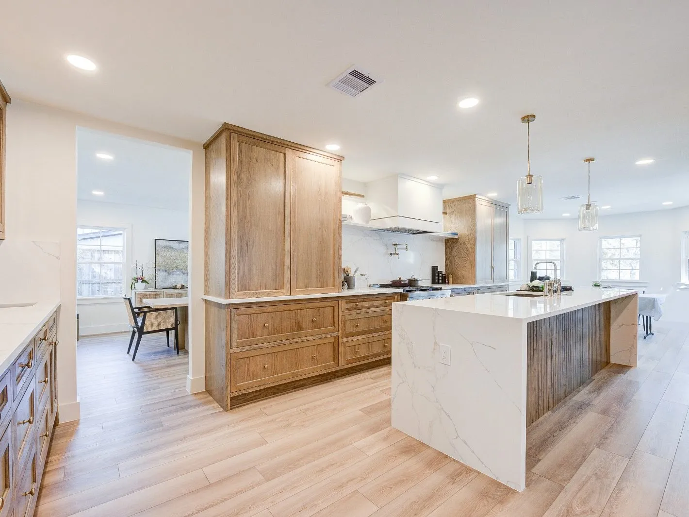 Open-plan kitchen looking through to the dining room after a remodel in The Woodlands, TX