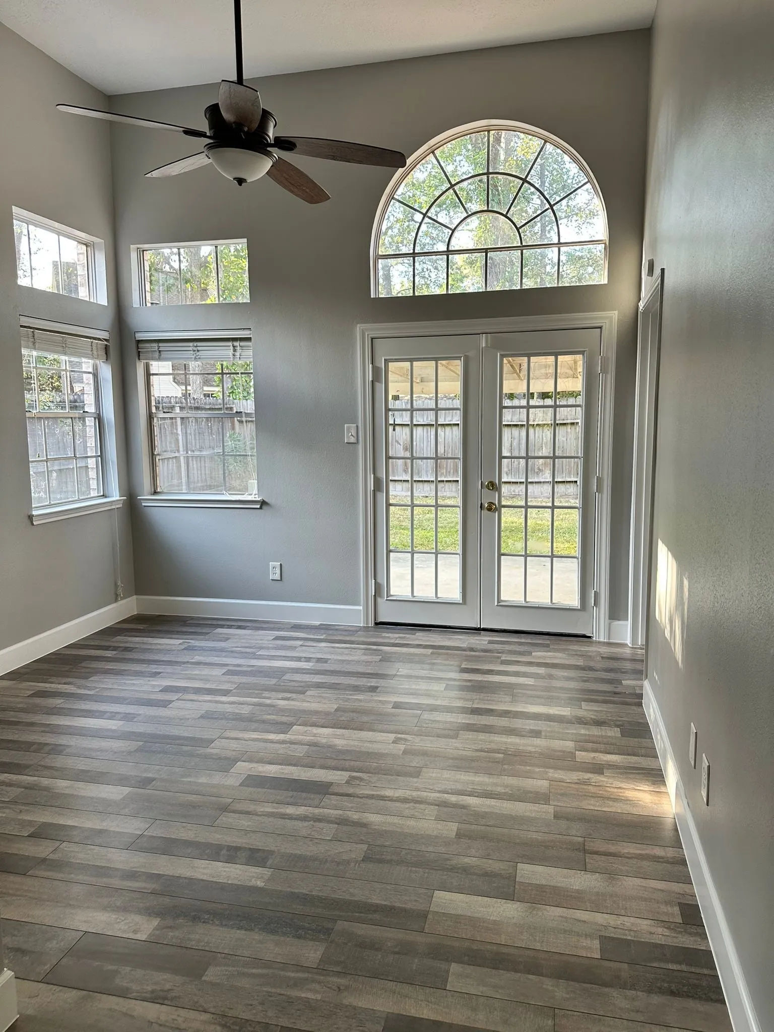 Whole home renovation with new plank flooring and arched windows in Panther Creek, The Woodlands, TX