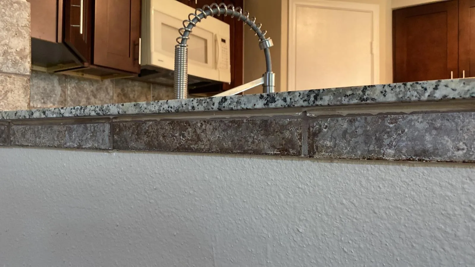 Granite counter and bar top edge detail in a kitchen remodel in The Woodlands, TX