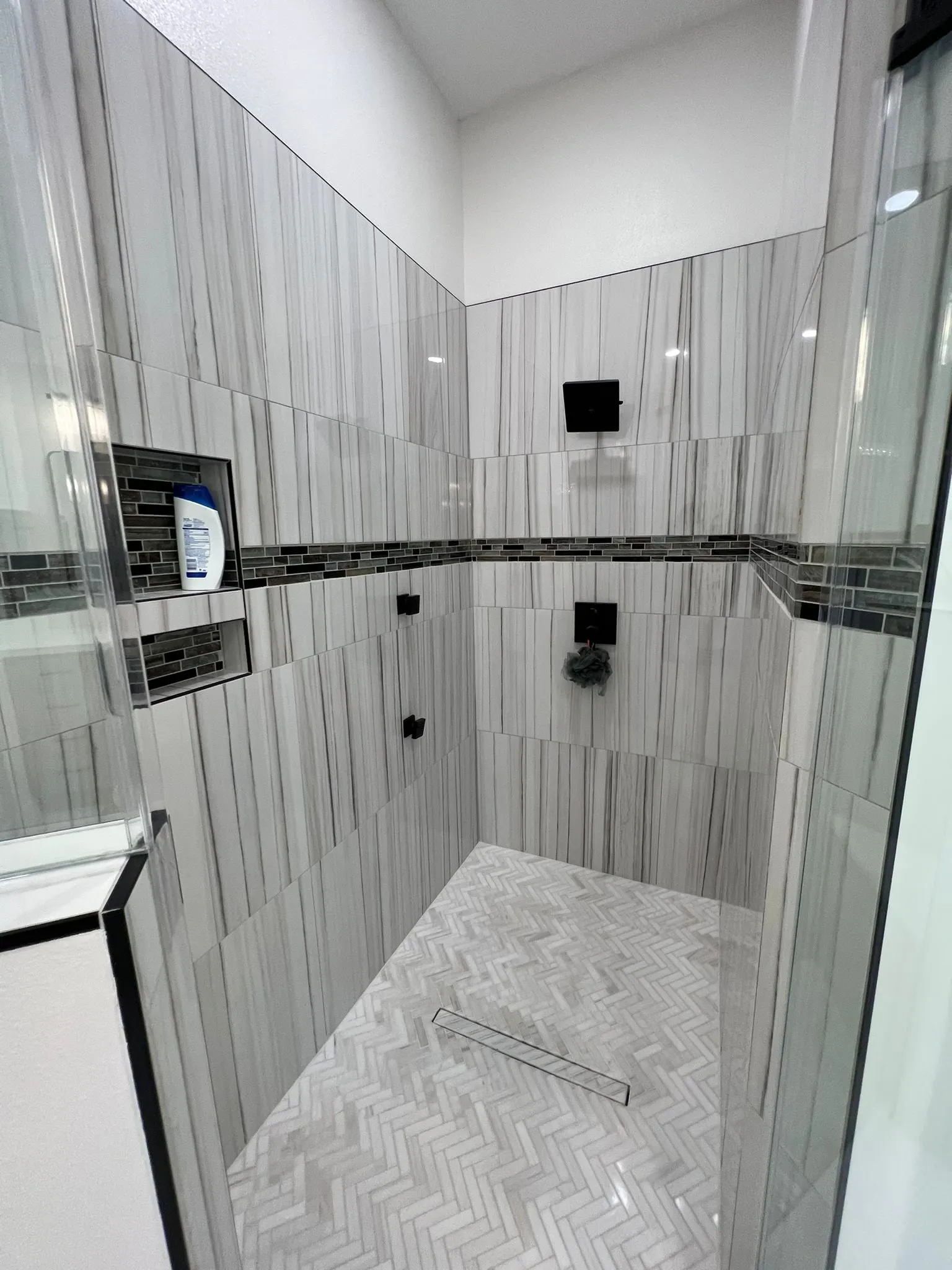 Primary bathroom suite with a freestanding tub and a curbless stone wet room in Sterling Ridge, The Woodlands, TX