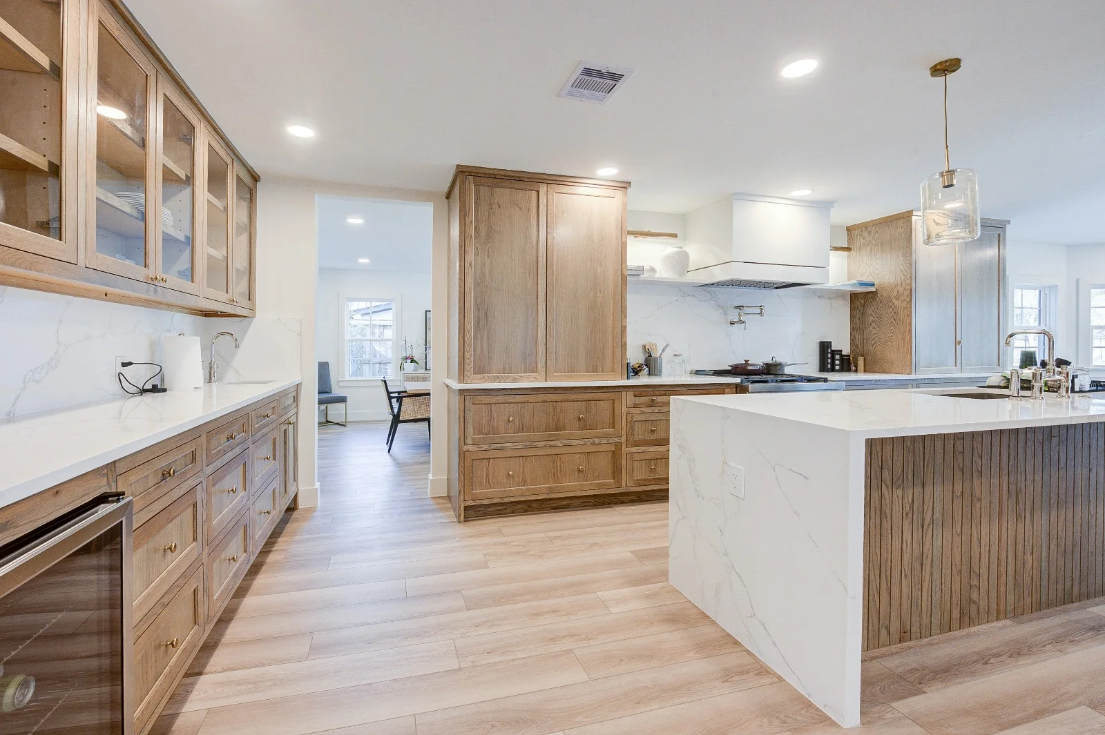 Wide plank flooring running through a remodeled kitchen in The Woodlands, TX